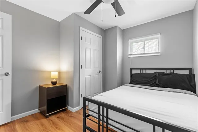 a bedroom with a bed and wooden floor