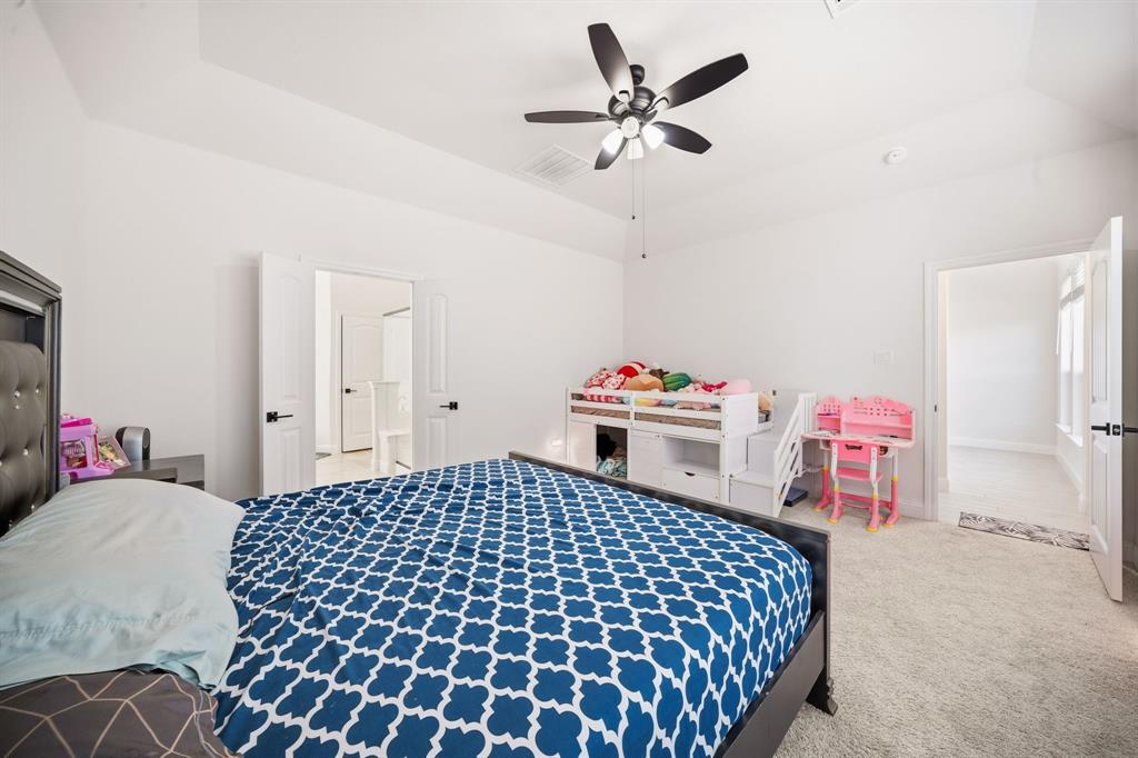 3841 Eagles Bluff Road Midlothian, TX 76065 - Photo 16 of 36 a bedroom with a bed and a chandelier