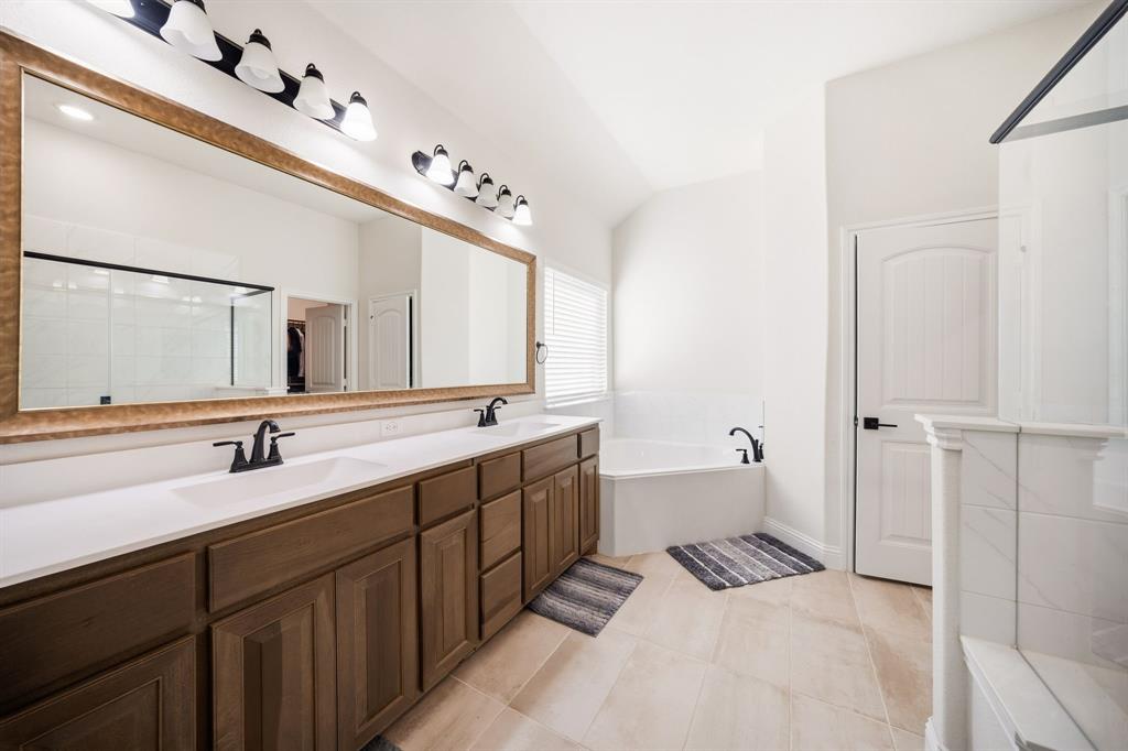 3841 Eagles Bluff Road Midlothian, TX 76065 - Photo 19 of 36 a spacious bathroom with a double vanity sink mirror and bathtub
