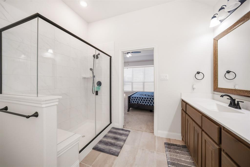 3841 Eagles Bluff Road Midlothian, TX 76065 - Photo 20 of 36 a bathroom with a double vanity sink a mirror and shower