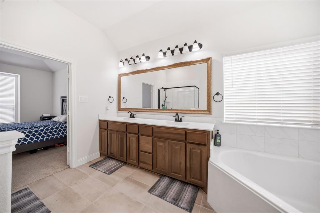 3841 Eagles Bluff Road Midlothian, TX 76065 - Photo 21 of 36 a bathroom with a double vanity sink mirror and bathtub