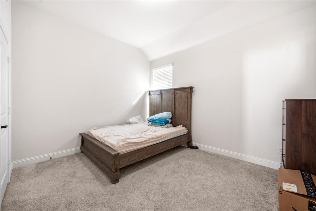 3841 Eagles Bluff Road Midlothian, TX 76065 - Photo 23 of 36 a bedroom with a bed and a table