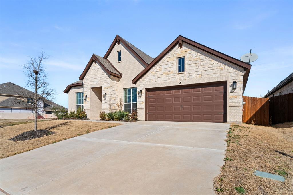 3841 Eagles Bluff Road Midlothian, TX 76065 - Photo 30 of 36 a front view of a house with a yard and garage