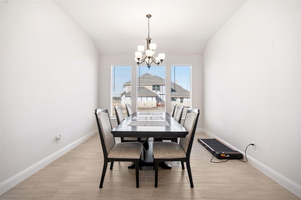3841 Eagles Bluff Road Midlothian, TX 76065 - Photo 7 of 36 a view of a dining room with furniture and chandelier