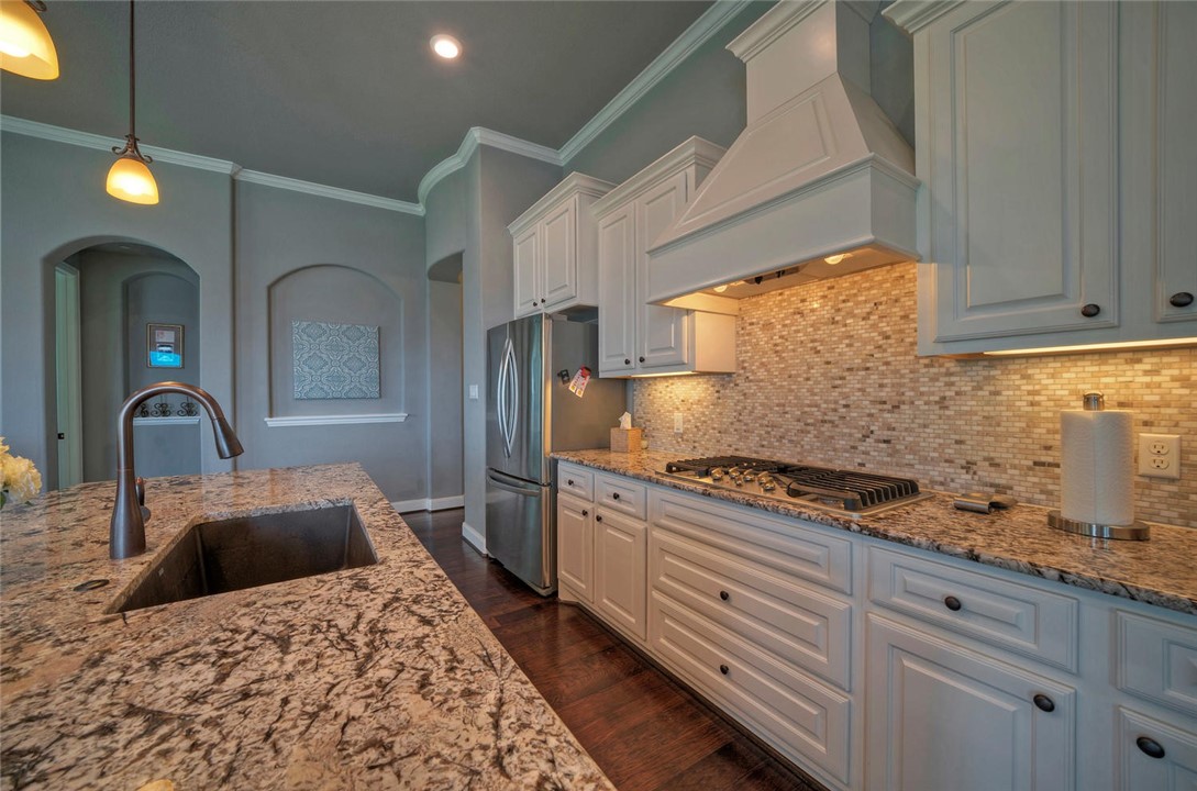 101 Maxwell Way Austin, TX 78738 - Photo 16 of 40 a kitchen with stainless steel appliances granite countertop a stove a sink and a refrigerator