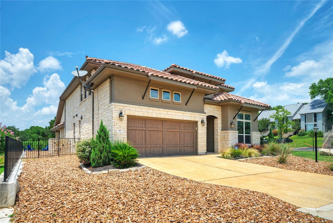 101 Maxwell Way Austin, TX 78738 - Photo 2 of 40 a front view of a house with a yard