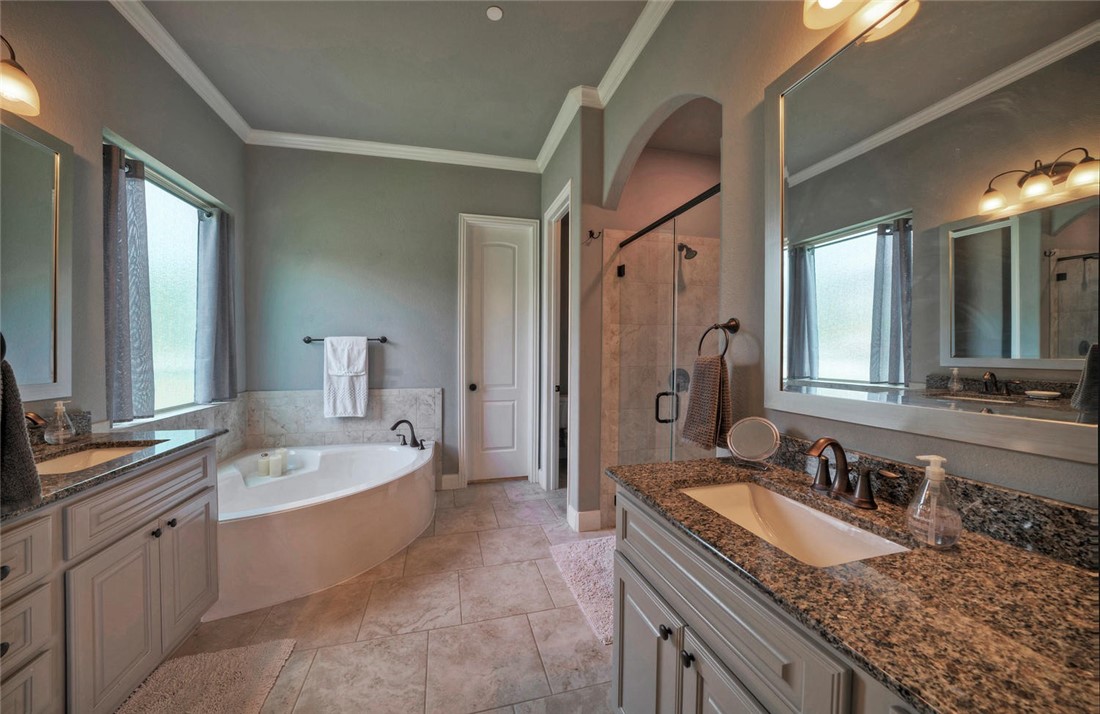 101 Maxwell Way Austin, TX 78738 - Photo 21 of 40 a bathroom with a granite countertop double vanity sink and a bathtub