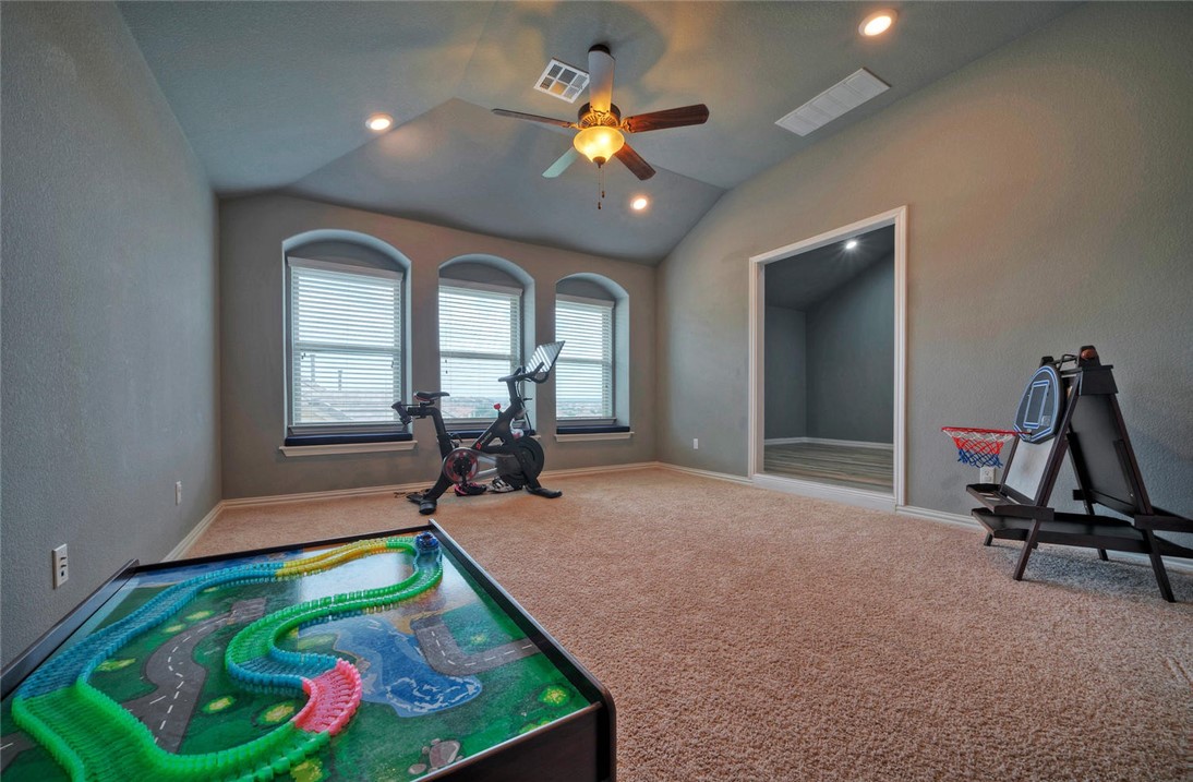 101 Maxwell Way Austin, TX 78738 - Photo 28 of 40 a room with pool table gym equipment wooden floor and a chandelier