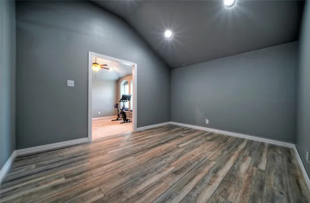 a view of a room with wooden floor