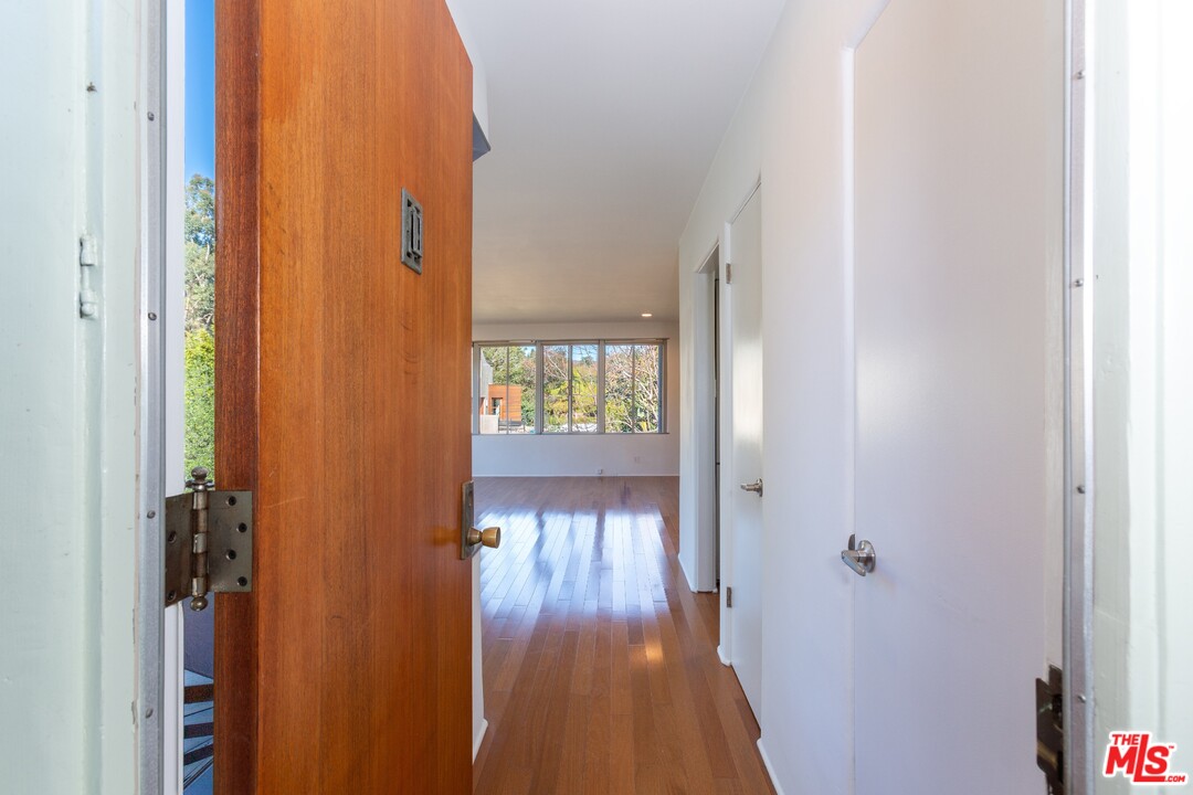 491 Mesa Road Santa Monica, CA 90402 - Photo 3 of 24 a view of a hallway with wooden floor