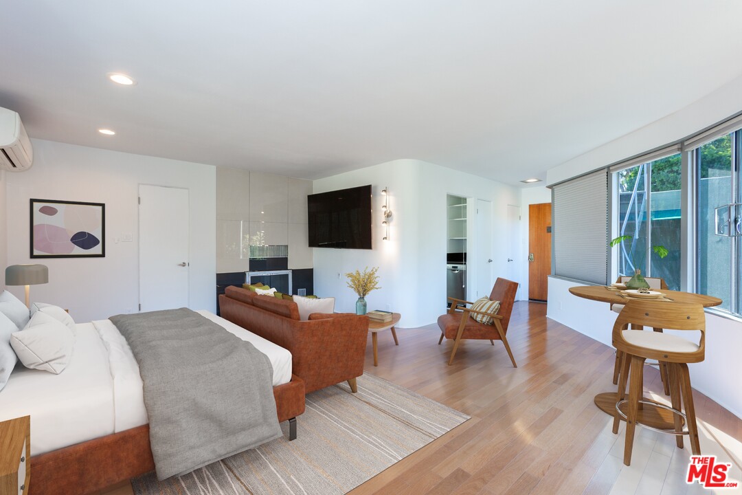 491 Mesa Road Santa Monica, CA 90402 - Photo 7 of 24 a living room with furniture a large window and a flat screen tv