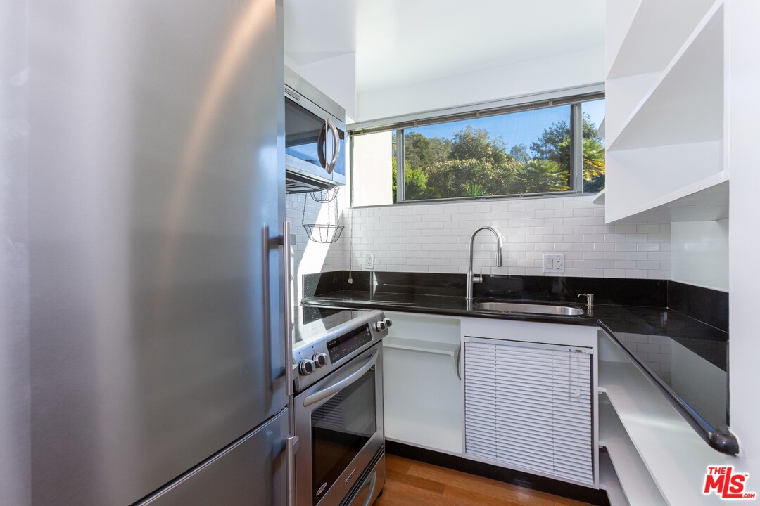 491 Mesa Road Santa Monica, CA 90402 - Photo 10 of 24 a kitchen with a sink and cabinets