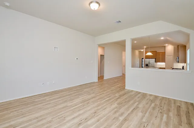a view of a kitchen and a window in a room
