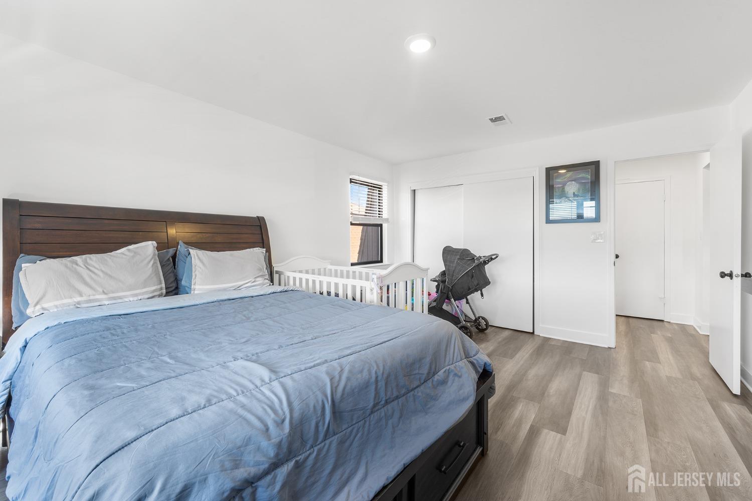 1609 Raspberry Court Edison, NJ 08817 - Photo 14 of 18 a bedroom with a bed and wooden floor