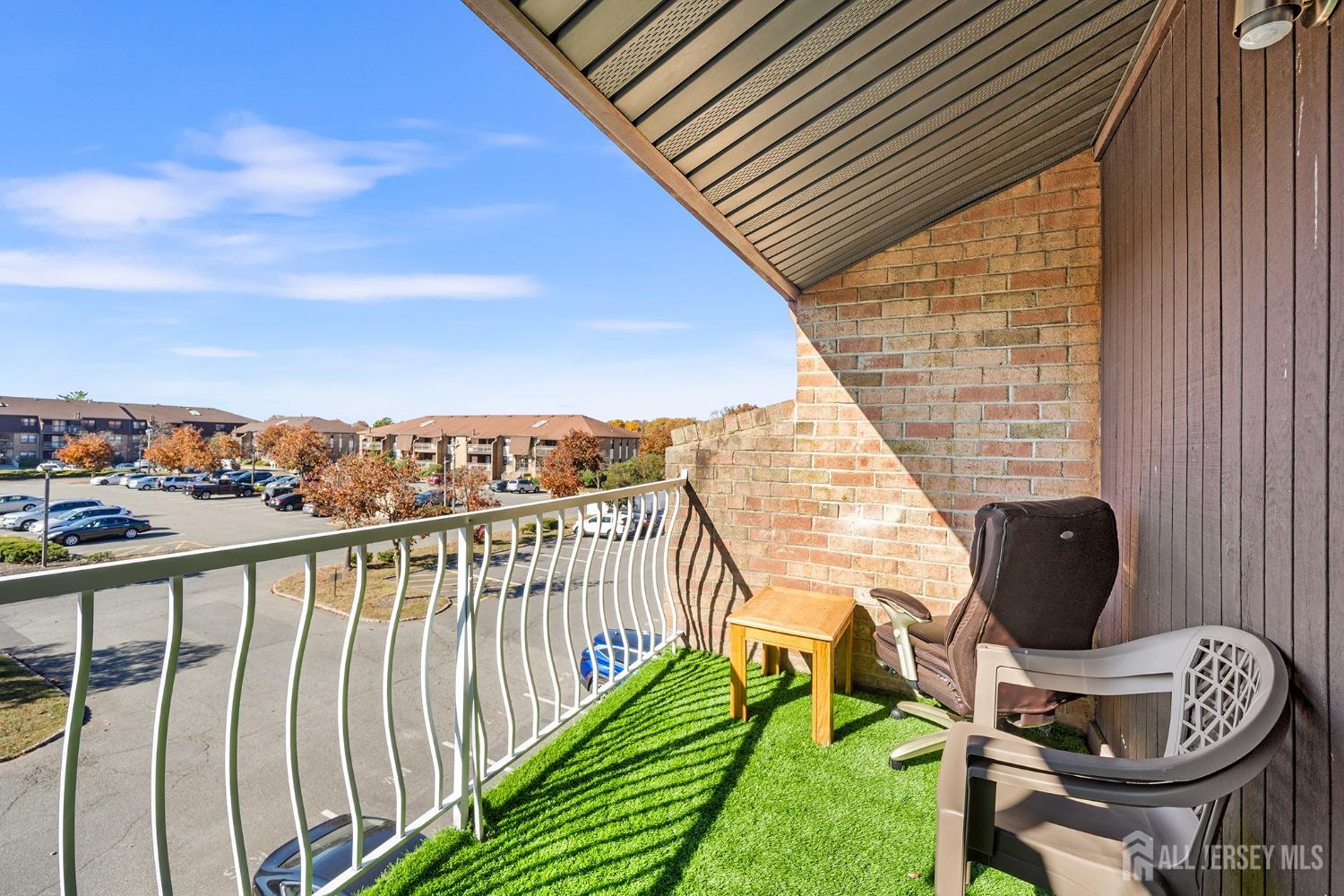 1609 Raspberry Court Edison, NJ 08817 - Photo 17 of 18 a balcony with chairs and a potted plant on the roof