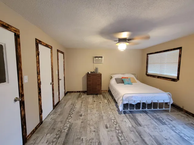 a bedroom with a bed and a chandelier