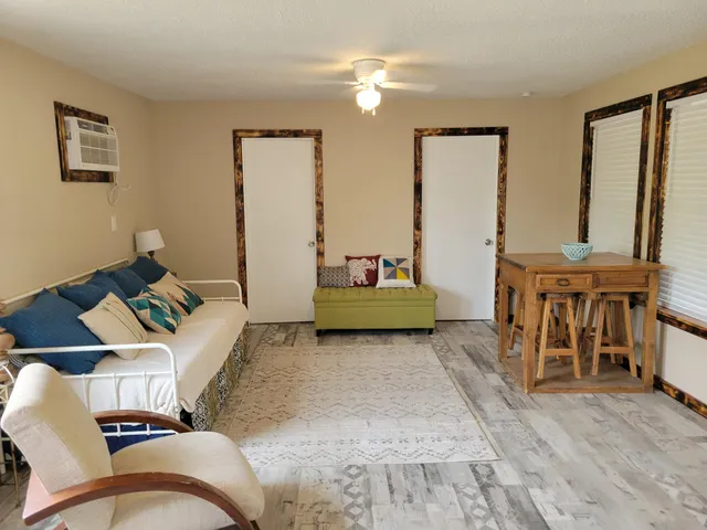 a living room with furniture and a dining table