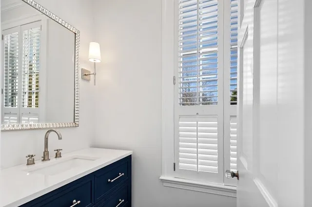 a bathroom with a toilet a sink and a mirror