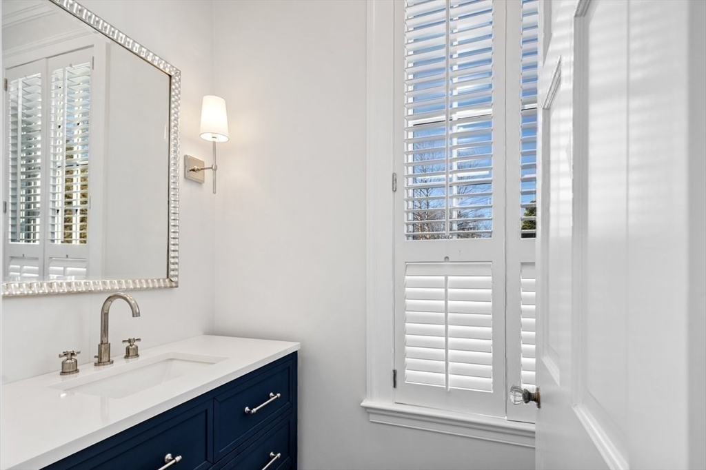 10 R Martins Lane Hingham, MA 02043 - Photo 16 of 40 a bathroom with a sink a vanity and a mirror