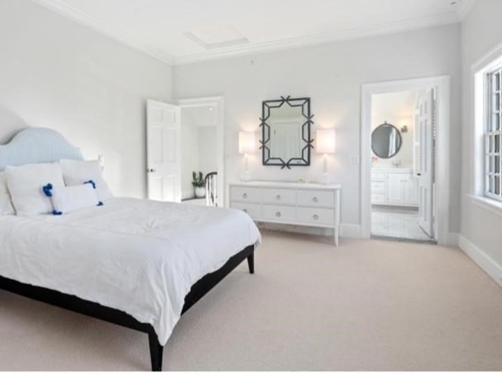 10 R Martins Lane Hingham, MA 02043 - Photo 22 of 40 a bedroom with a bed and a mirror