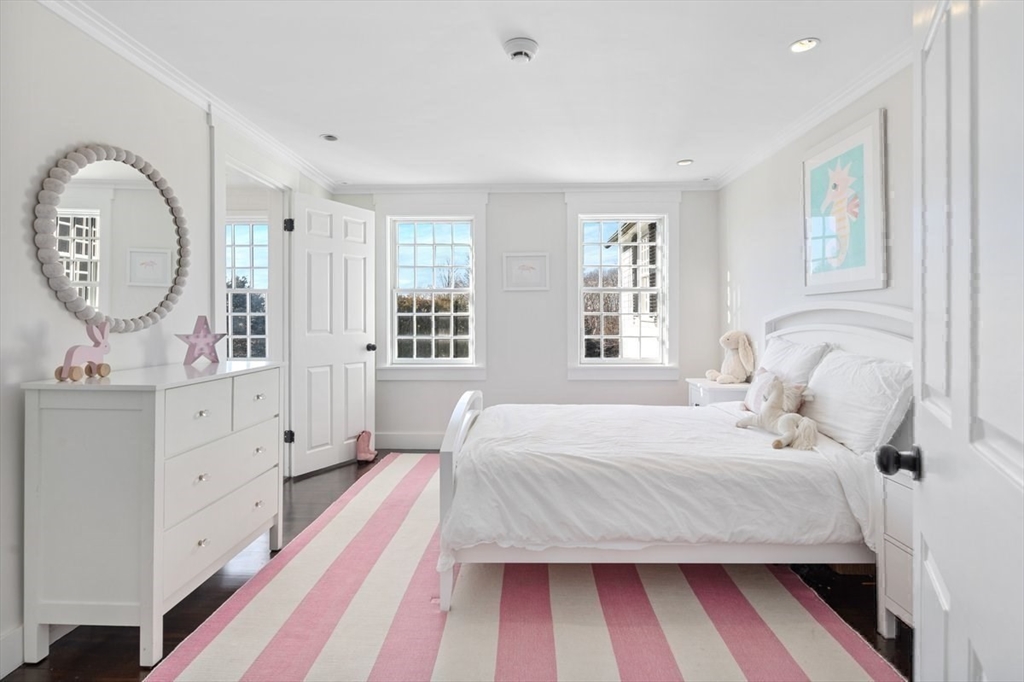 10 R Martins Lane Hingham, MA 02043 - Photo 25 of 40 a bedroom with a large bed and a mirror