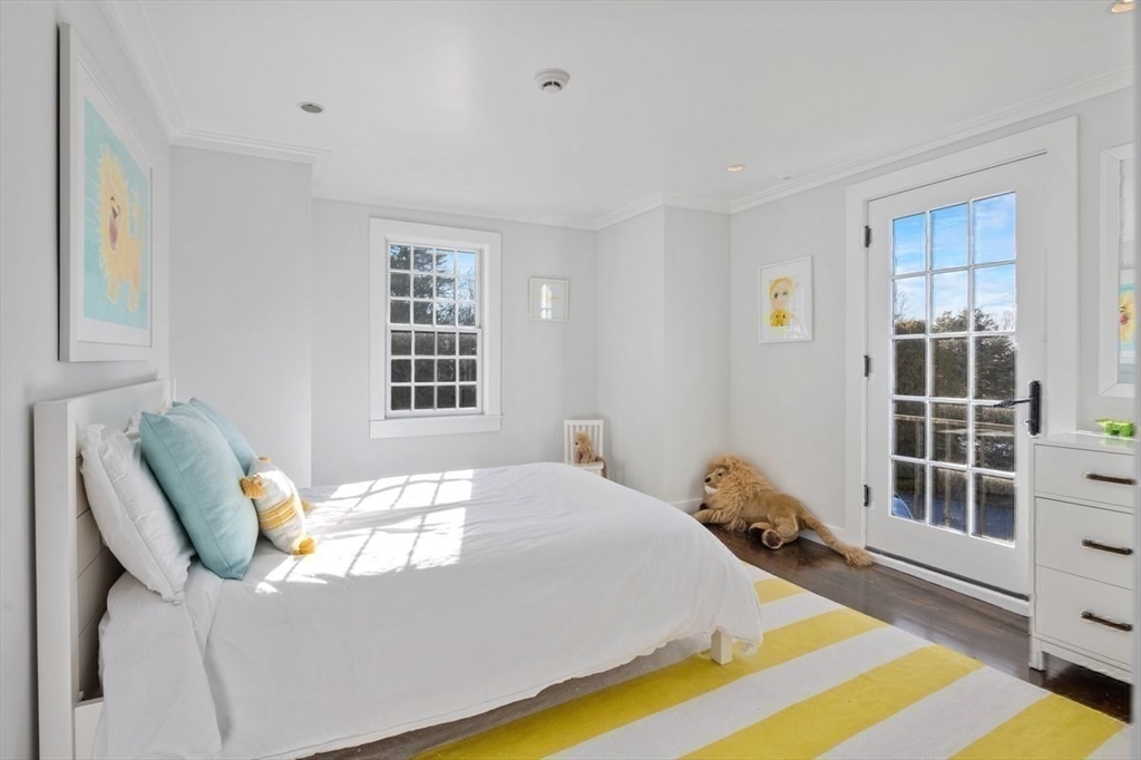 10 R Martins Lane Hingham, MA 02043 - Photo 27 of 40 a bed sitting in a bedroom next to a window