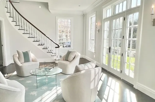 a living room with furniture and a large window with glass windows