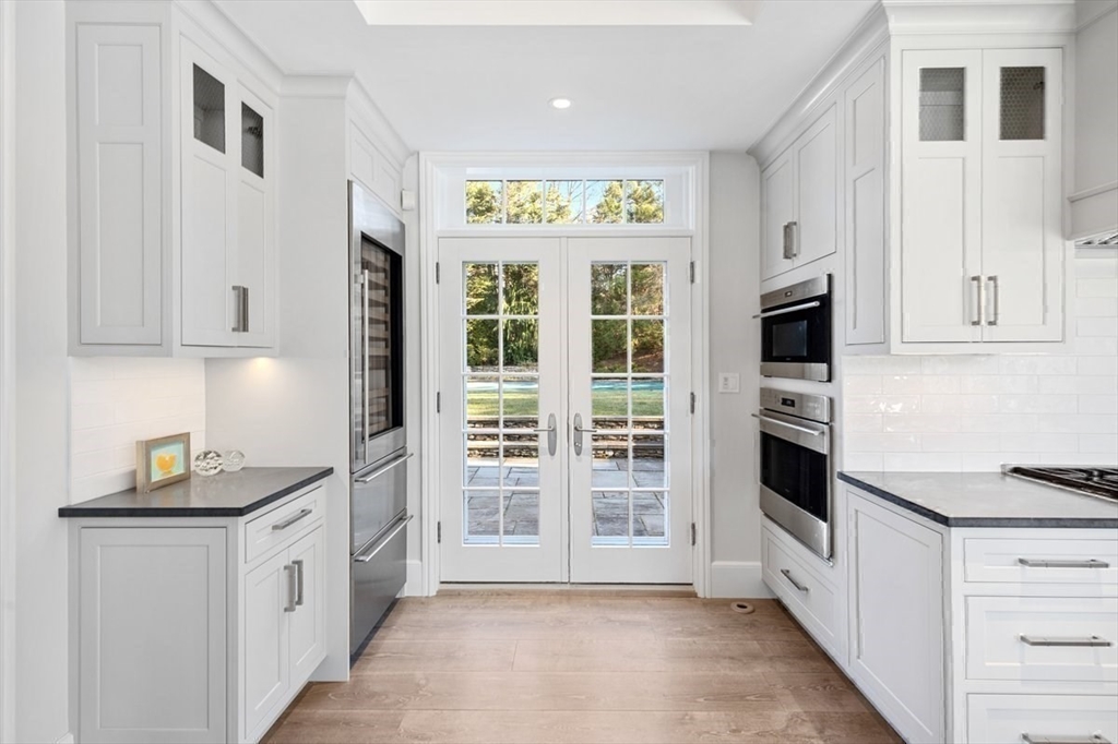 10 R Martins Lane Hingham, MA 02043 - Photo 9 of 40 a kitchen with stainless steel appliances white cabinets and a window