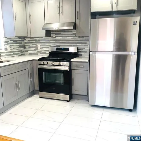 a kitchen with cabinets and appliances