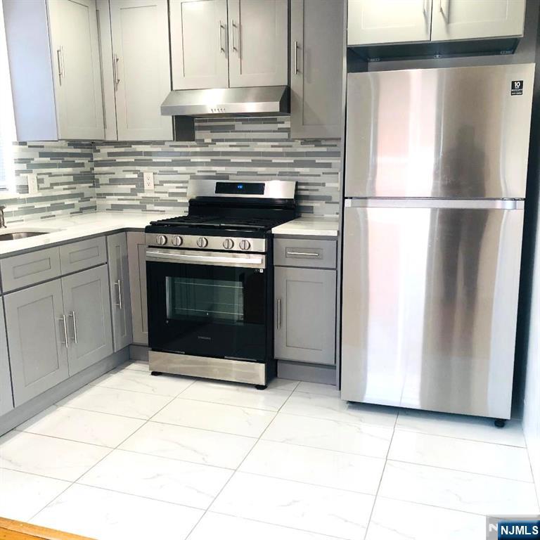 a kitchen with cabinets and appliances