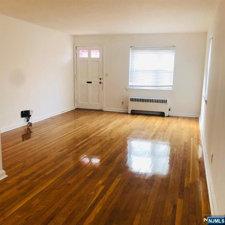 460 Club Way, Unit 43 Hackensack, NJ 07601 - Photo 3 of 10 a view of an empty room with wooden floor and a window