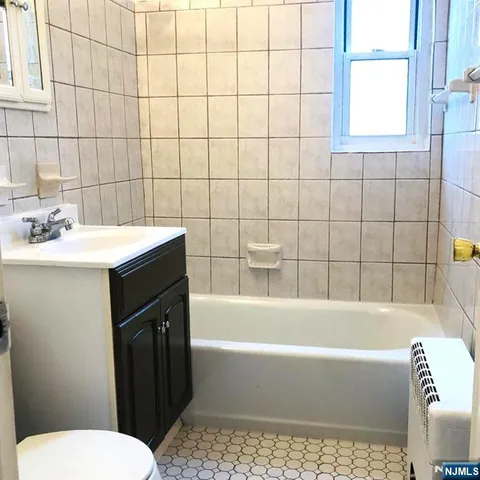 a bathroom with a sink a toilet and bathtub