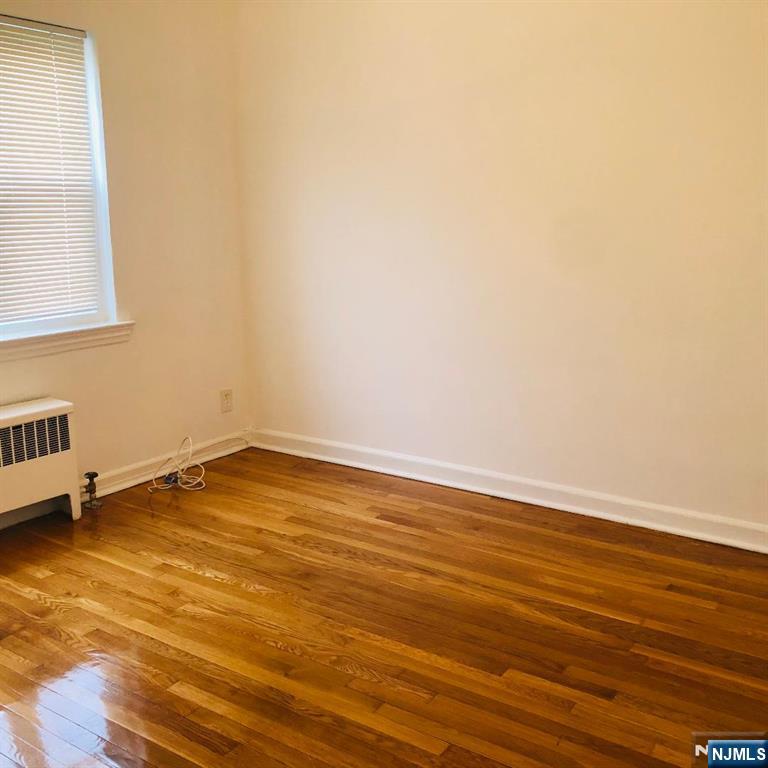 460 Club Way, Unit 43 Hackensack, NJ 07601 - Photo 9 of 10 an empty room with wooden floor and a window