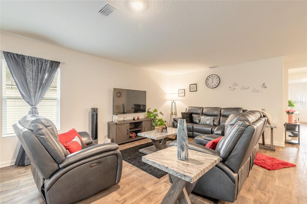 82 Hulett Wds Road Palm Coast, FL 32137 - Photo 16 of 48 a living room with furniture fireplace and a flat screen tv