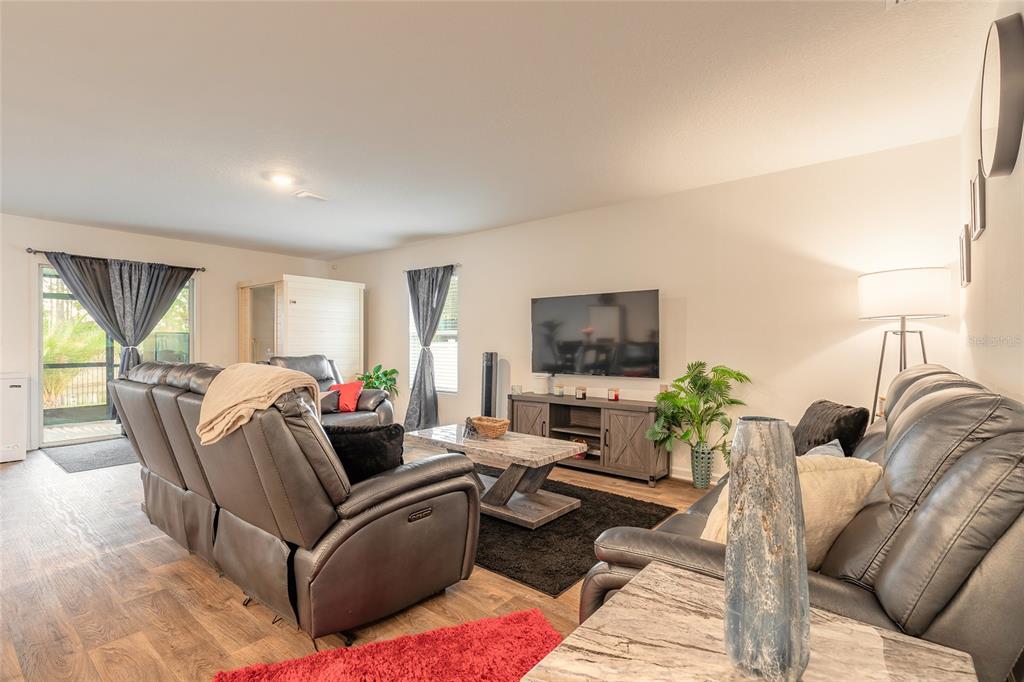 82 Hulett Wds Road Palm Coast, FL 32137 - Photo 17 of 48 a living room with furniture and a flat screen tv