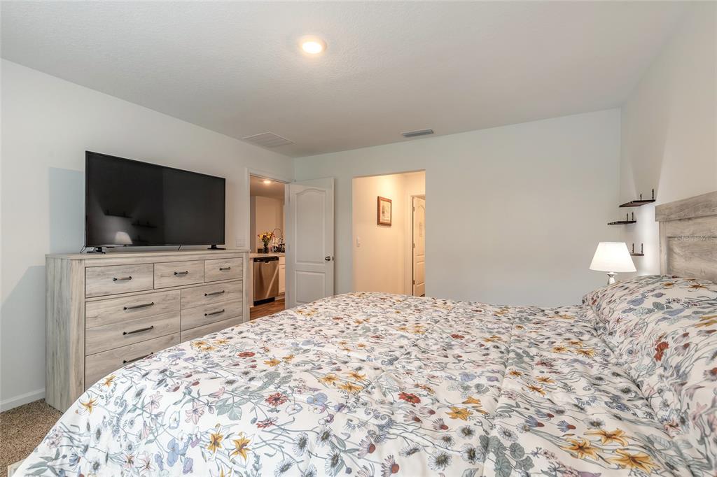 82 Hulett Wds Road Palm Coast, FL 32137 - Photo 21 of 48 a bedroom with a bed and a flat screen tv