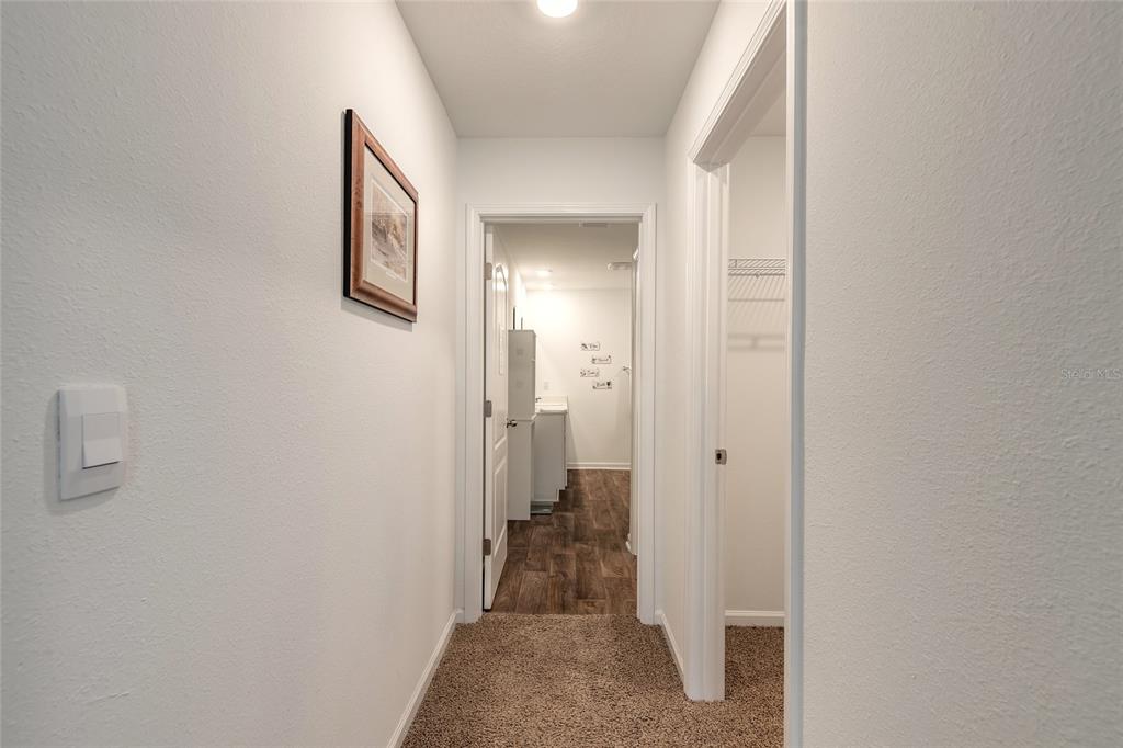 82 Hulett Wds Road Palm Coast, FL 32137 - Photo 22 of 48 a view of a hallway with a livingroom and a bathroom with sink