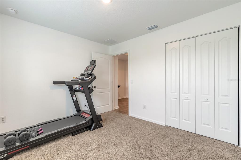 82 Hulett Wds Road Palm Coast, FL 32137 - Photo 28 of 48 a view of a room with gym equipment
