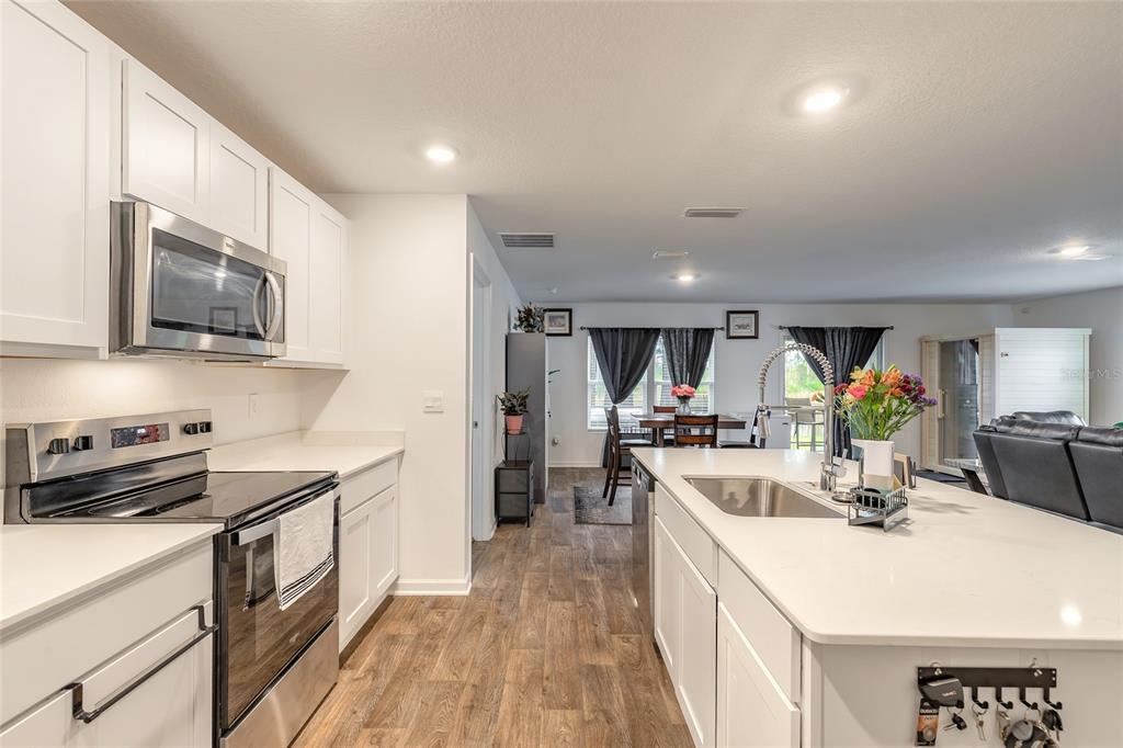 82 Hulett Wds Road Palm Coast, FL 32137 - Photo 10 of 48 a kitchen with stainless steel appliances granite countertop a sink stove and refrigerator