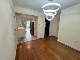 5110 Academy Street, Unit 4 Houston, TX 77005 - Photo 7 of 8 a room with wooden floor and white walls
