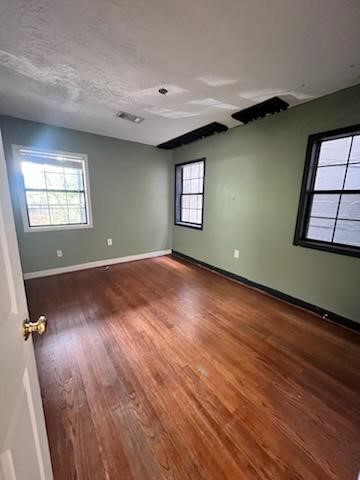 5110 Academy Street, Unit 4 Houston, TX 77005 - Photo 8 of 8 an empty room with wooden floor and windows