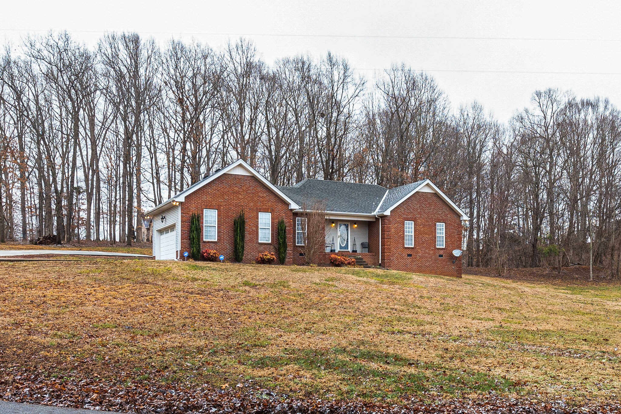 113 Lear Road Portland, TN 37148 - Photo 1 of 28 a front view of a house with a yard and trees