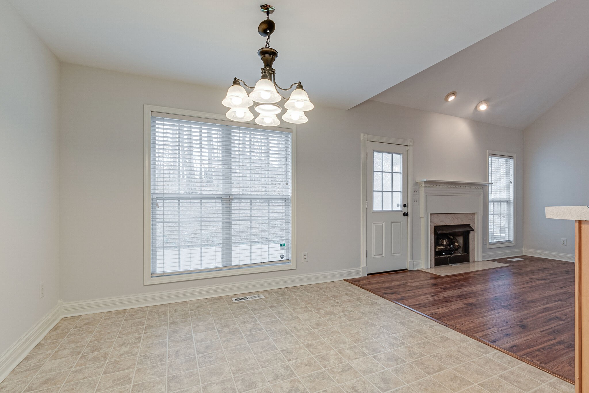 113 Lear Road Portland, TN 37148 - Photo 11 of 28 an empty room with windows fireplace and wooden floor