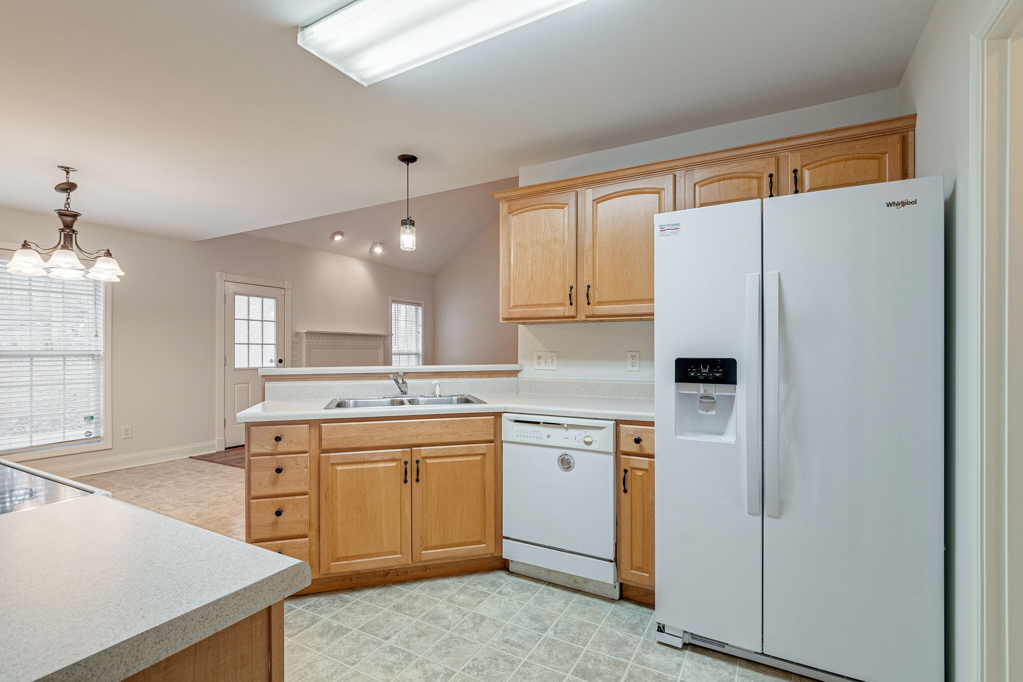 113 Lear Road Portland, TN 37148 - Photo 14 of 28 a kitchen with a sink a refrigerator and cabinets