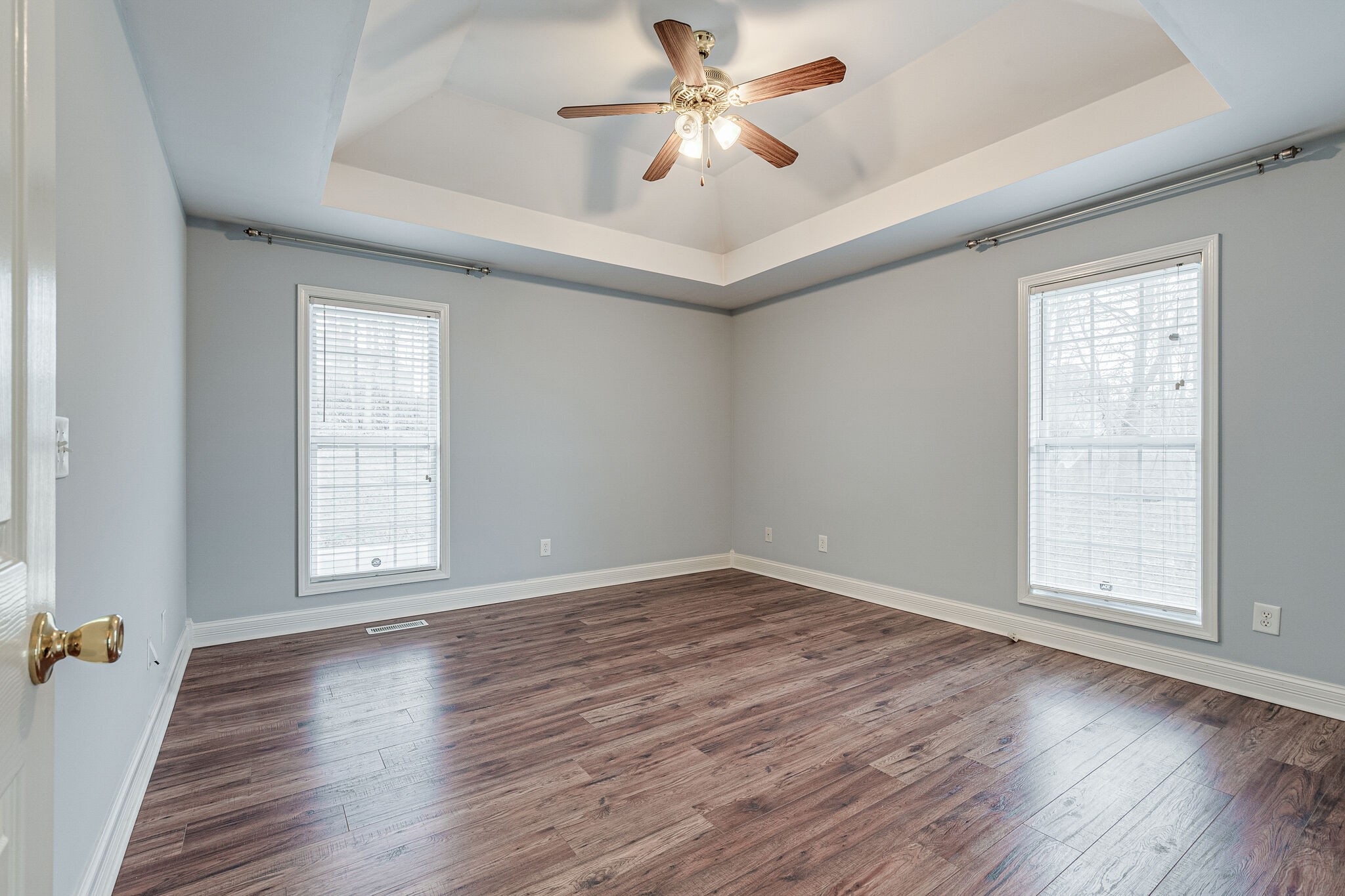 113 Lear Road Portland, TN 37148 - Photo 17 of 28 an empty room with wooden floor chandelier fan and windows