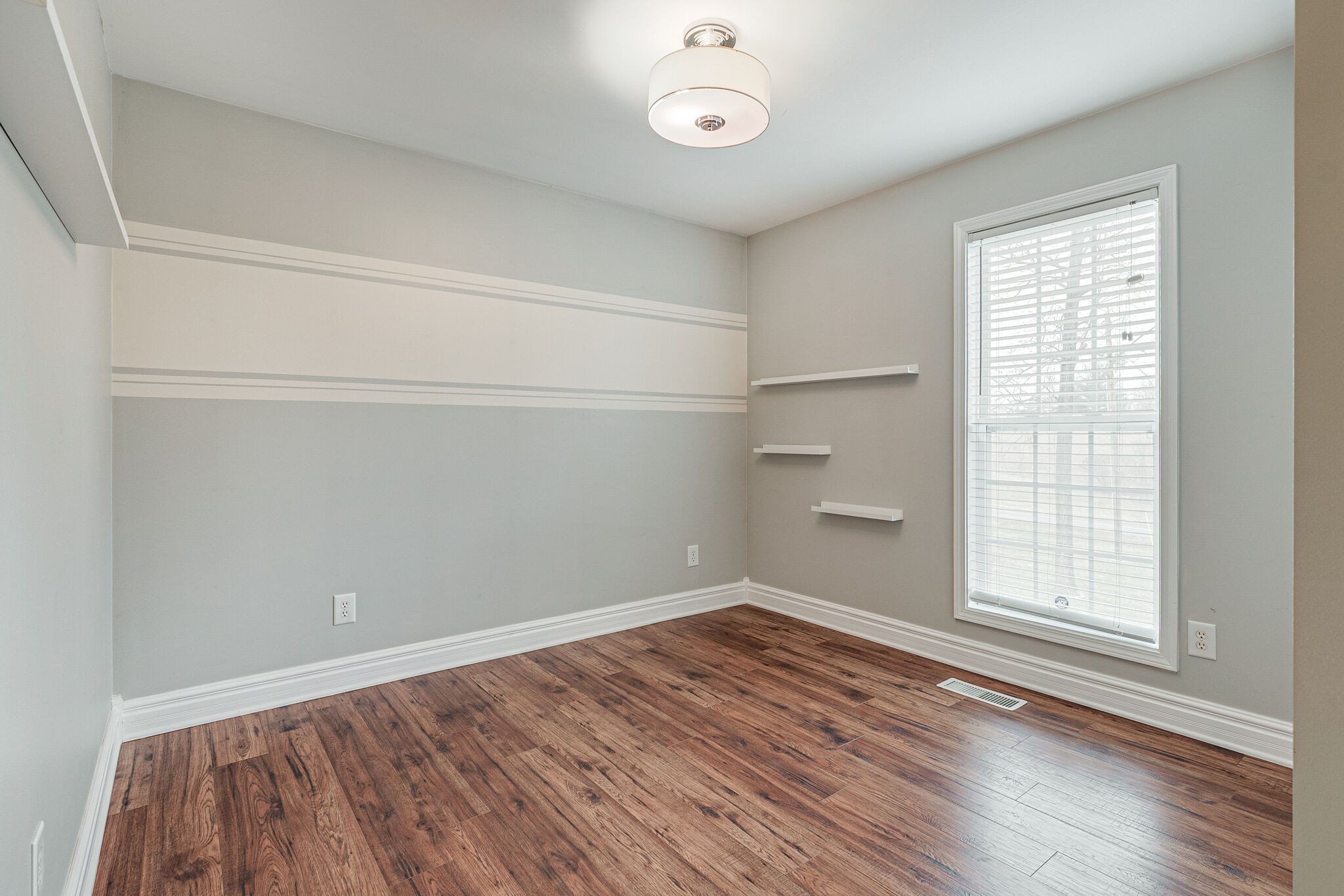 113 Lear Road Portland, TN 37148 - Photo 21 of 28 an empty room with wooden floor and windows