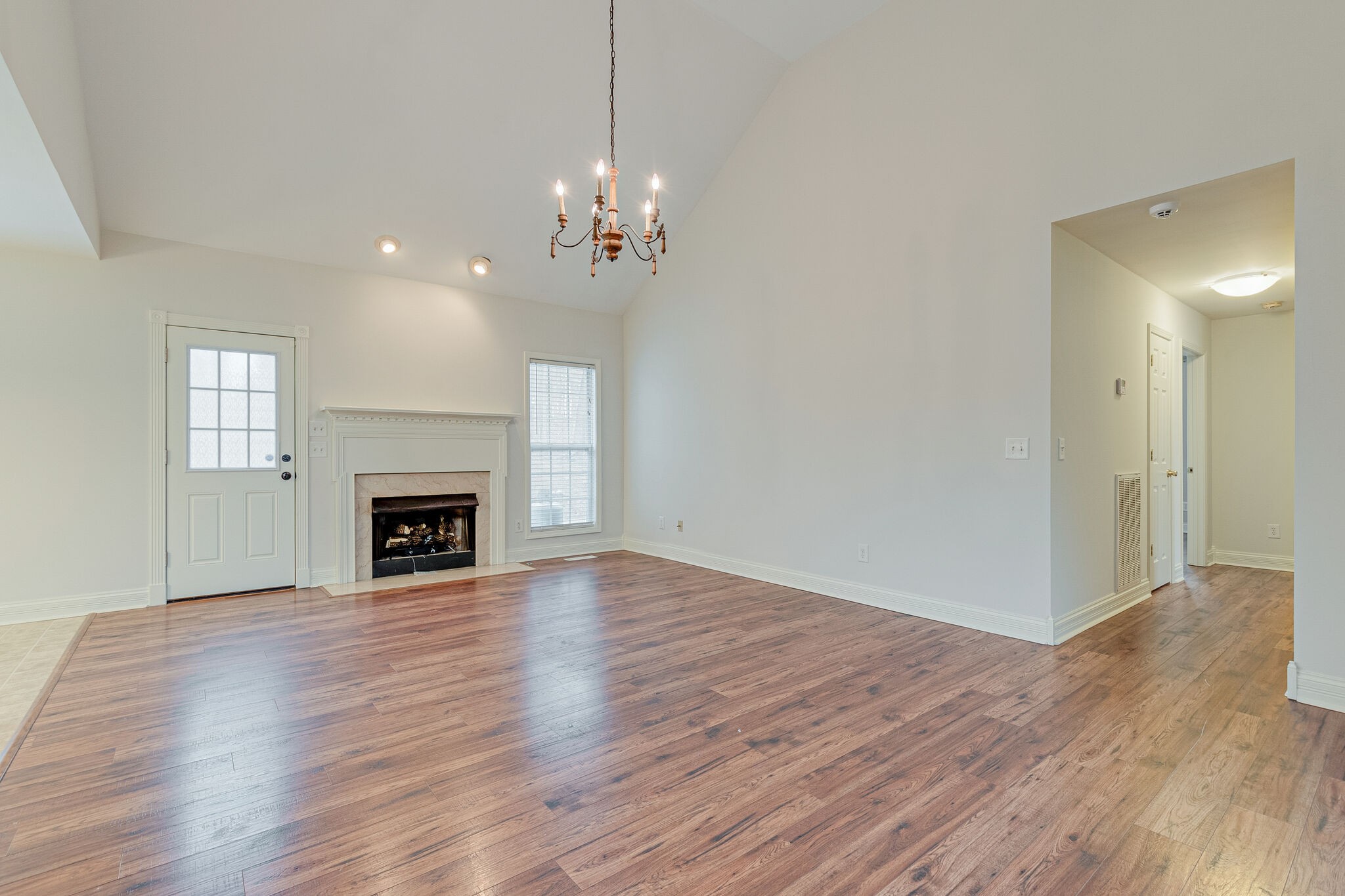 113 Lear Road Portland, TN 37148 - Photo 8 of 28 a view of a livingroom with a fireplace wooden floor and windows
