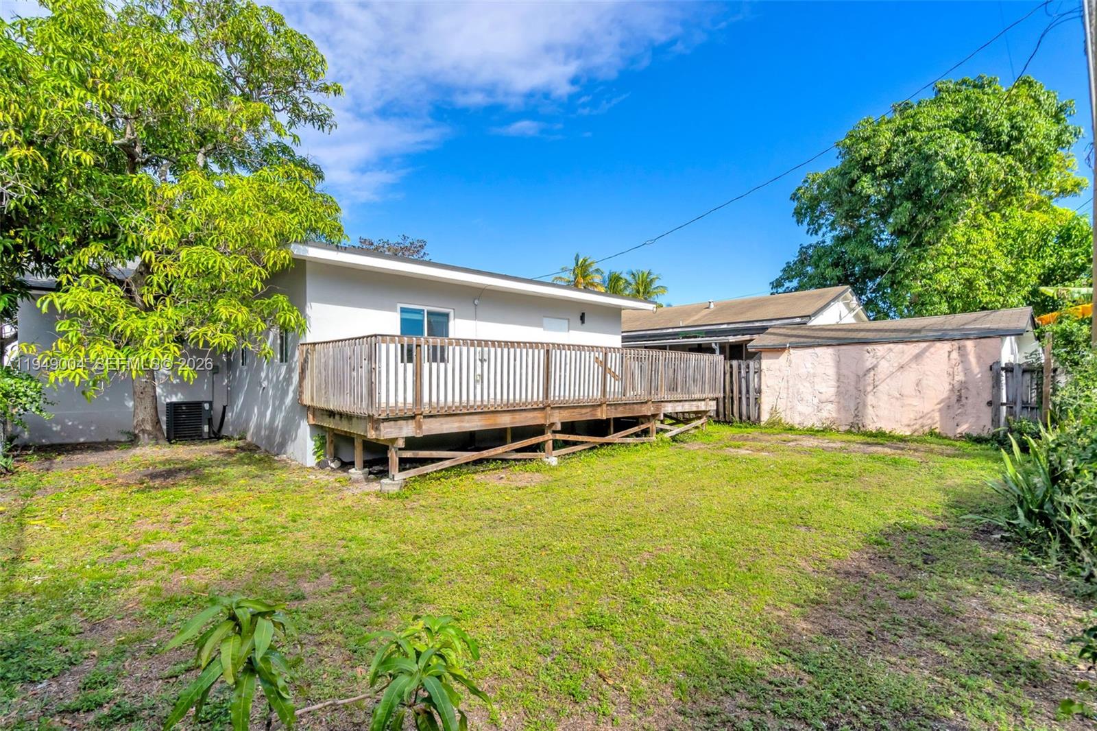 1786 Southwest 14th Terrace Miami, FL 33145 - Photo 34 of 41 a backyard of a house with table and chairs plants and large tree