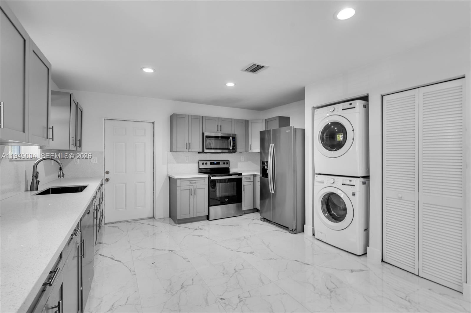 1786 Southwest 14th Terrace Miami, FL 33145 - Photo 8 of 41 a kitchen with granite countertop a sink a stove top oven and refrigerator