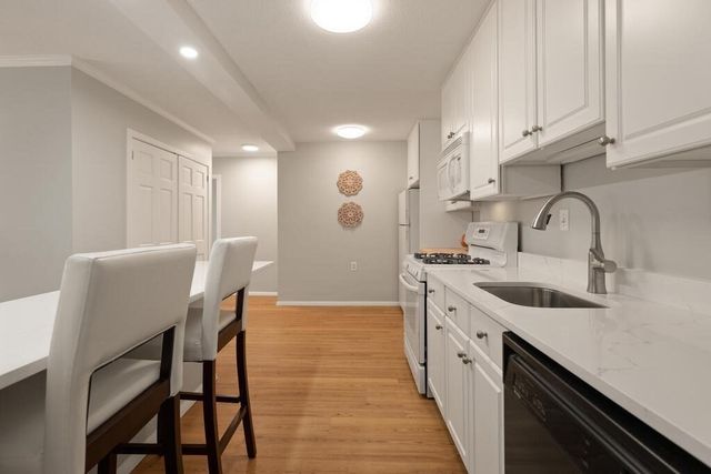 a kitchen with stainless steel appliances kitchen island granite countertop a sink and cabinets